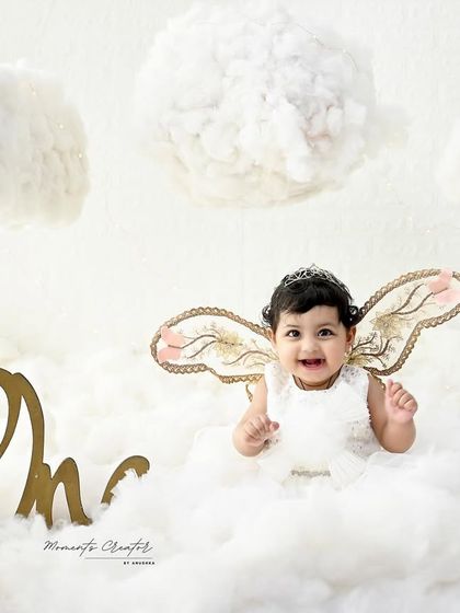 Thumbs up for being one! This little angel's happy gesture and bright smile make this one of the most joyful and adorable photos.