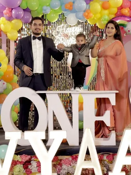 The perfect family portrait in front of a vibrant birthday setup. This shot from a first birthday in Gurgaon shows how I capture the entire scene, including the decor, the cake, and the happy family at the center of it all.