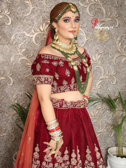 A closer look at the off-shoulder blouse and heavy jewellery. The combination of the velvet fabric and the intricate gold embroidery makes this a very regal rental choice.