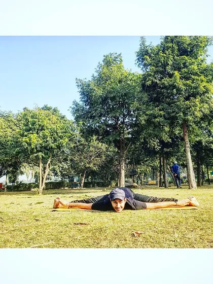 Our co-founder Nishant Sir performing a full split (Samakonasana) in the park, surrounded by the tranquility of nature.