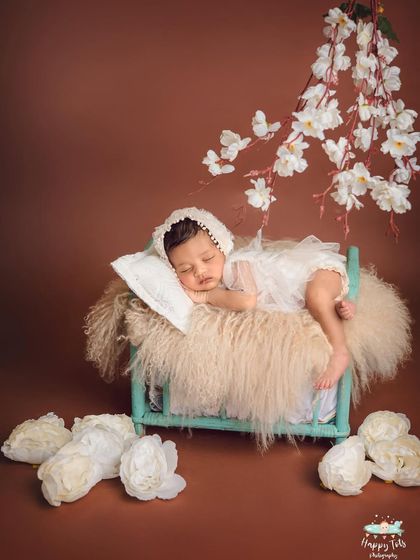 A dreamy setup with a miniature bed and soft, flowing fabrics. We create these serene scenes to capture the angelic nature of your newborn.