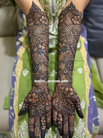 A classic and timeless full bridal mehendi design, with perfectly executed details from the fingertips to the elbows.
