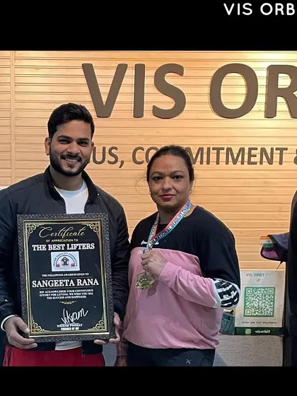 Presenting the "Best Lifter" certificate to a deserving member of our team. Recognizing hard work is a core part of our gym culture.