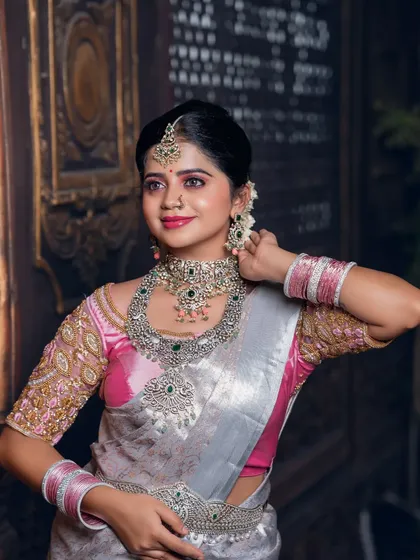 A close-up of the silver and pink saree look, showing the intricate blouse embroidery.