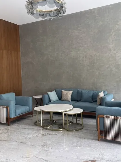 A wider view of the living room in Tiripur, showcasing the complete set of our custom-made sofas, chairs, and tables.