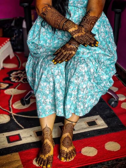 A full look at bride Revathi's hands and feet. The matching mandala designs create a cohesive and beautiful bridal statement.