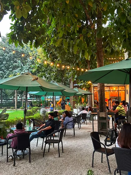The outdoor seating area is perfect for enjoying a sunny day, with a playground nearby for kids.