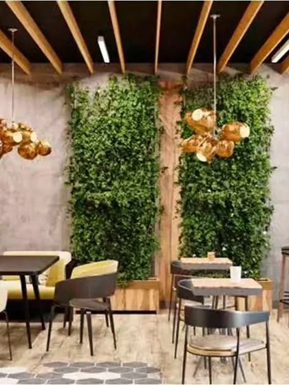 For this cafe, we created a warm and eclectic atmosphere using a mix of textures. The design combines exposed brick walls, statement green walls for a touch of nature, and varied seating arrangements including booth, bar, and table seating to cater to different customer groups.