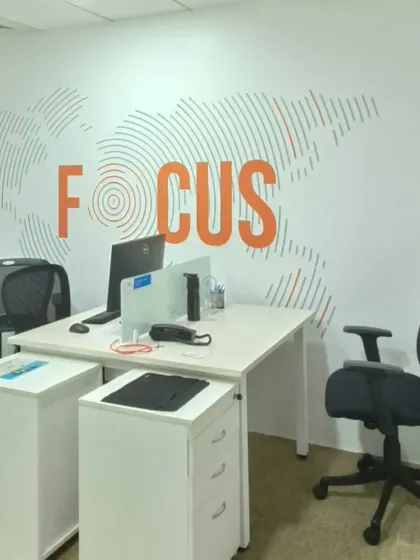 For this corporate office in Bangalore, we installed a motivational wall mural with the word 'FOCUS' over a world map graphic. This custom design helps create a productive and globally-minded workspace for the team.