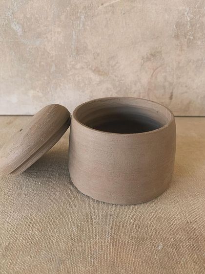 This cylindrical jar with its perfectly fitted lid is another example of the beautiful, raw forms our students create. The focus here is on precision and simplicity.