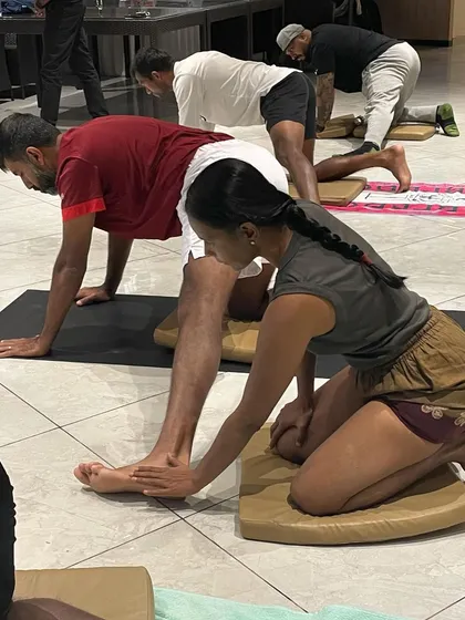 Adjusting the foot and ankle in a preparatory lunge. Precise alignment from the ground up ensures that the joints are protected and the muscles are working efficiently.