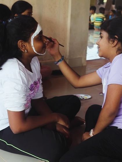 Campers paint each other's faces, a great bonding activity that encourages creativity and teamwork.