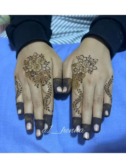 A minimalist floral design, perfect for those who prefer a more subtle look. The dark fingertips add a traditional touch.