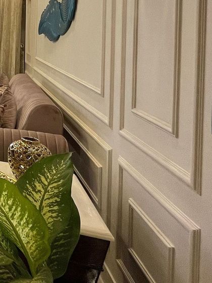 A close-up of the wainscoting detail. This simple addition of POP moulding adds immense character and a sense of architectural quality to the walls.