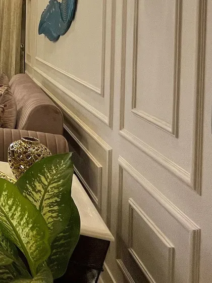 A close-up of the wainscoting detail. This simple addition of POP moulding adds immense character and a sense of architectural quality to the walls.