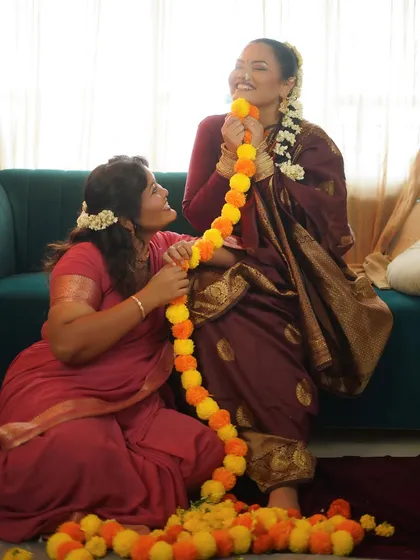 A playful and candid moment captured during the shoot, filled with laughter and festive flowers.