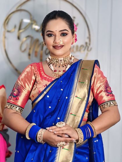 A portrait of the model in the royal blue saree, showing the perfect blend of traditional attire and modern makeup.
