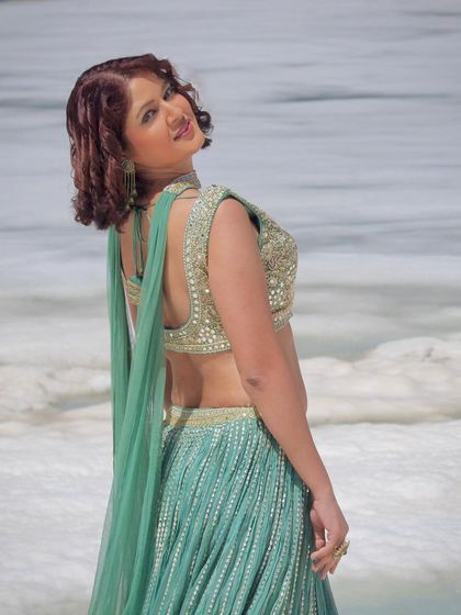 A smiling shot that captures the joy of wearing a beautiful outfit in a stunning location.