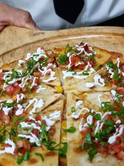 Freshly made quesadillas, sliced and ready to serve. This is a perfect kid-friendly option that's easy to eat and always a crowd-pleaser.