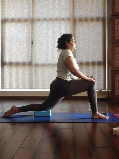 Finding a gentle opening in the low lunge with the back knee supported by a block. Small adjustments like this make a big difference.