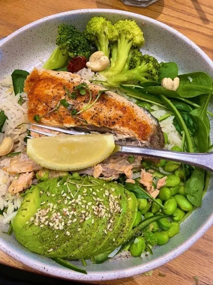 This is my ideal healthy dinner bowl. It features pan-seared salmon cooked in butter, served with fresh greens, avocado, edamame, and a sprinkle of nuts. It's a perfect balance of high-quality protein, healthy fats, and fiber.