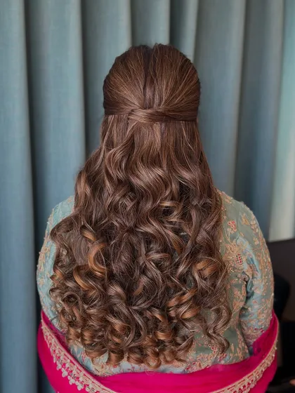 A classic half-updo with a neat twist, and the rest of the hair in defined, bouncy curls.