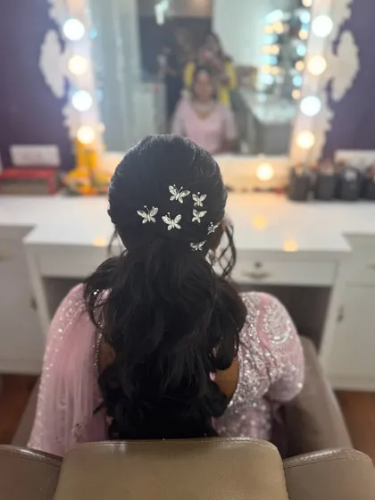 A detailed view of the butterfly hair accessories in Surya's ponytail. These delicate clips add a whimsical and modern touch to her hairstyle.