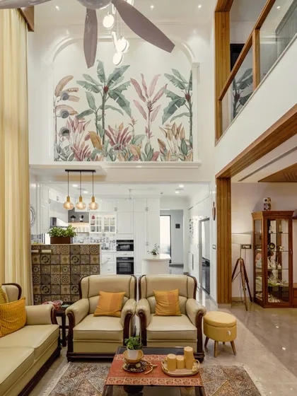 A wide shot of the living area from image 123, showing the staircase, mezzanine, and open kitchen.