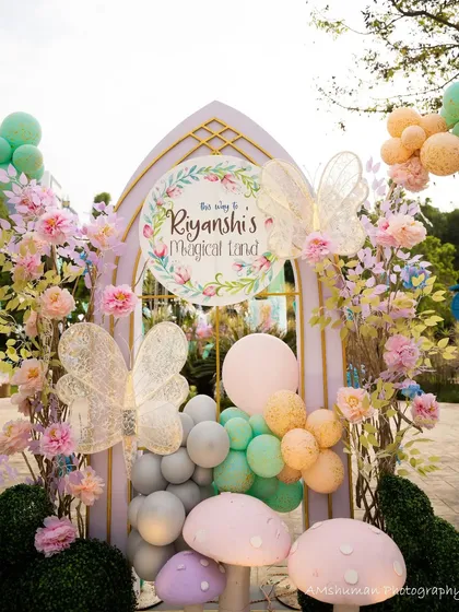 The magic begins the moment your guests arrive. I design breathtaking entrances like this floral and balloon archway for a fairyland party, complete with whimsical mushrooms and delicate butterfly wings to welcome everyone into a different world.
