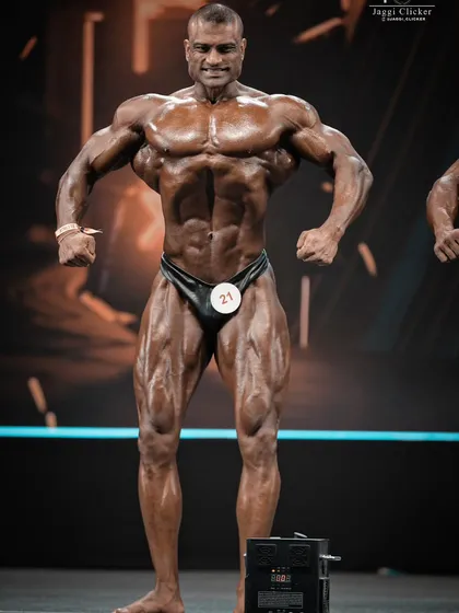 Here is a perfect example of the Front Relaxed pose executed on stage. This is the first impression you give the judges, and it needs to show symmetry, balance, and a commanding presence.