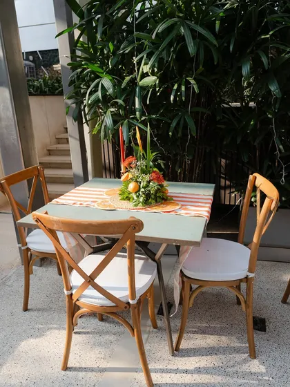 A styled seating area with a citrus-themed centerpiece, creating a cohesive look throughout the event space.