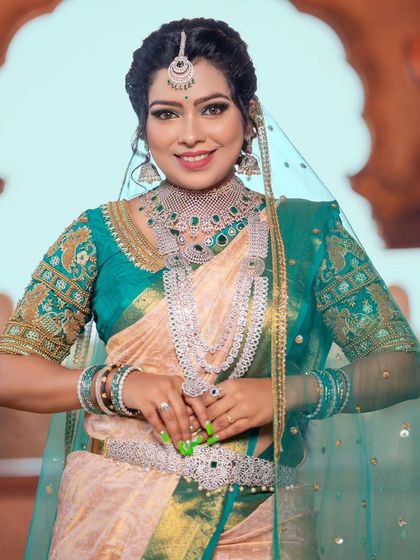 A smiling portrait of the model, showcasing the full grandeur of the layered diamond-look necklace and choker.