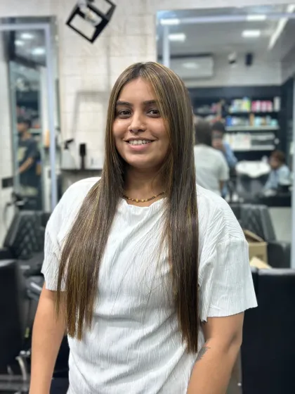 A frontal view showcasing the sleek, straight finish of the hair treatment. Her hair now frames her face perfectly, and the highlights add depth without compromising the smooth texture.