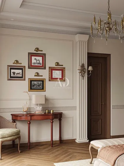 A detail shot showing the classic console table and gallery wall of equestrian art. These personal touches add character and a sense of history to the serene and muted bedroom.