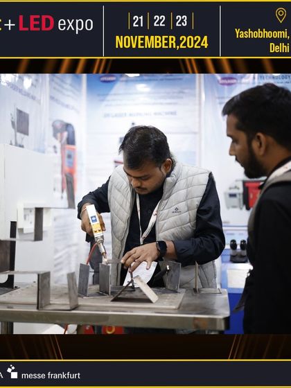 A live demonstration of lighting equipment assembly captures the attention of visitors, offering a look into the manufacturing process.