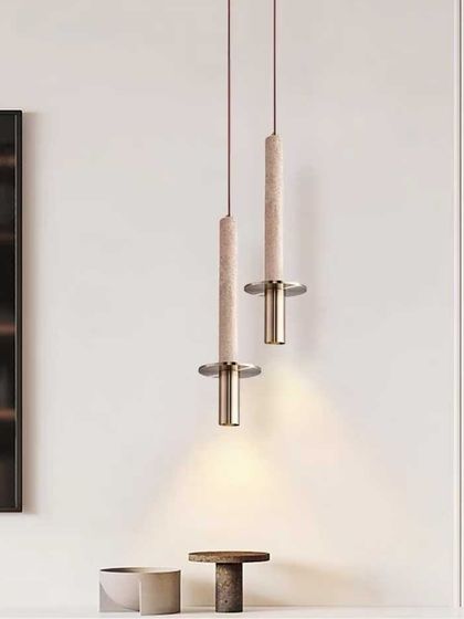 A pair of elegant pendant lights combining natural stone with brass fittings. This design is perfect for adding a touch of understated luxury to a modern space.