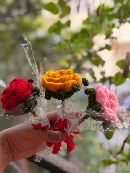 A collection of three single roses in red, yellow, and pink. You can mix and match colors to create a small, personalized bouquet.