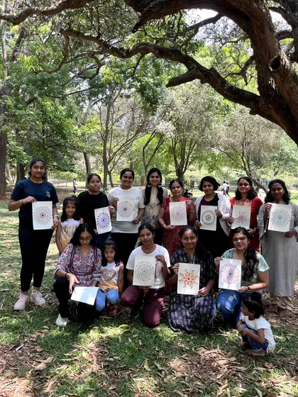 The full group from our dot mandala workshop posing with their finished pieces. It's a wonderful snapshot of a creative community brought together for a day of art in the park.