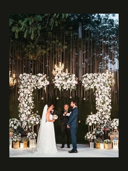 A wide shot of the stunning floral arch and altar where Gwen and Azhir said "I do" in an open garden ceremony.