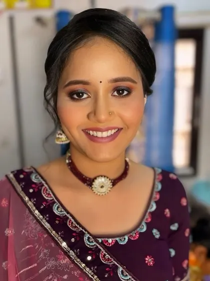 A happy and smiling portrait. The makeup is fresh and youthful, perfect for a wedding celebration.