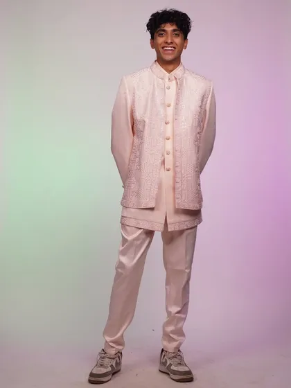 A full-length shot of the pastel pink Indo-Western set, perfect for the guy who isn't afraid of a little color.