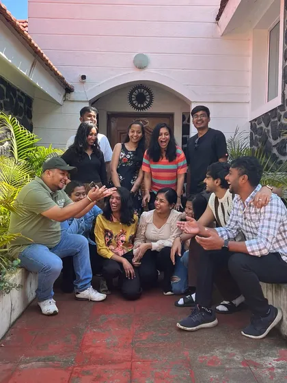 A candid, fun group moment outside our stay, sharing a laugh together.