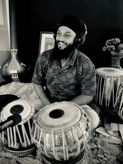 A candid moment during a recording session. The joy of playing is always there, even during the most focused and technical work.
