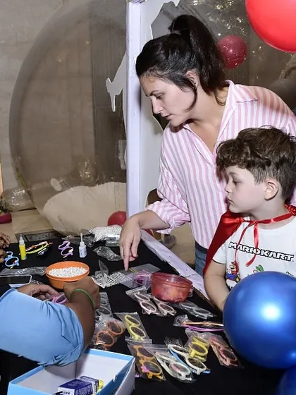 A mom helps her son pick out some cool superhero-themed glasses at one of the activity stations. I love seeing parents get involved in the fun.