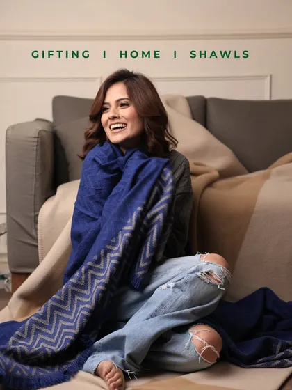 Experience the effortless blend of comfort and high fashion. Our luxurious royal blue shawl, featuring a contemporary chevron pattern, is styled here with casual denim for a relaxed yet sophisticated look. This piece showcases the versatility we design into every wrap, perfect for elevating your everyday style or adding a touch of elegance to a special occasion.