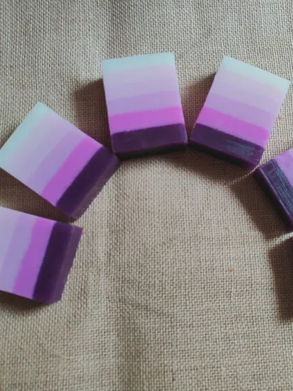 A set of five purple ombre layered soaps.
