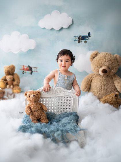 An adventurous little pilot exploring the skies with his teddy bear co-pilots.