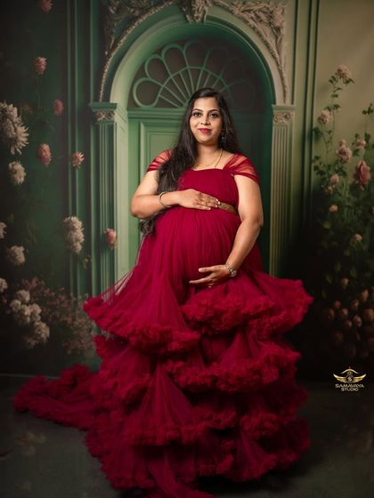 A stunning portrait of the mother-to-be in a dramatic, multi-layered red tulle gown. This is for the mama who wants to make a statement.