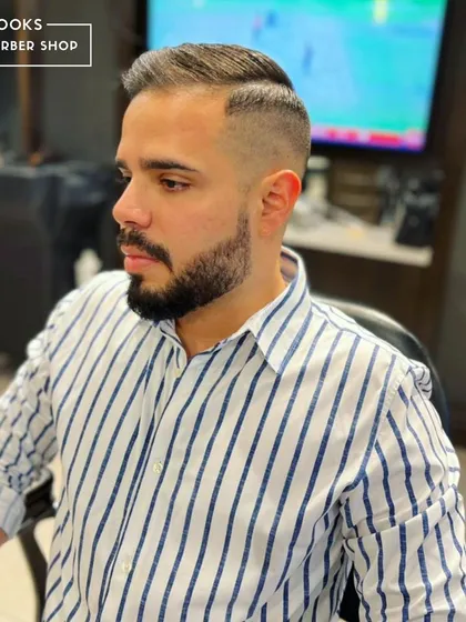 You can have 99 problems, but a good haircut won't be one of them. This client looks sharp and professional with a classic side-parted haircut and a clean fade.