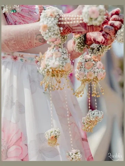 A close-up of the bride's beautiful floral kaleeras, a unique and delicate detail from her floral-themed mehendi.